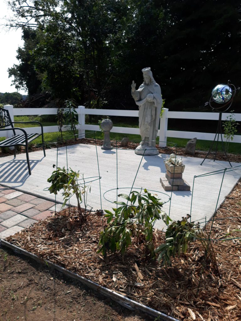 Photo of memorial garden with large statue of Jesus.