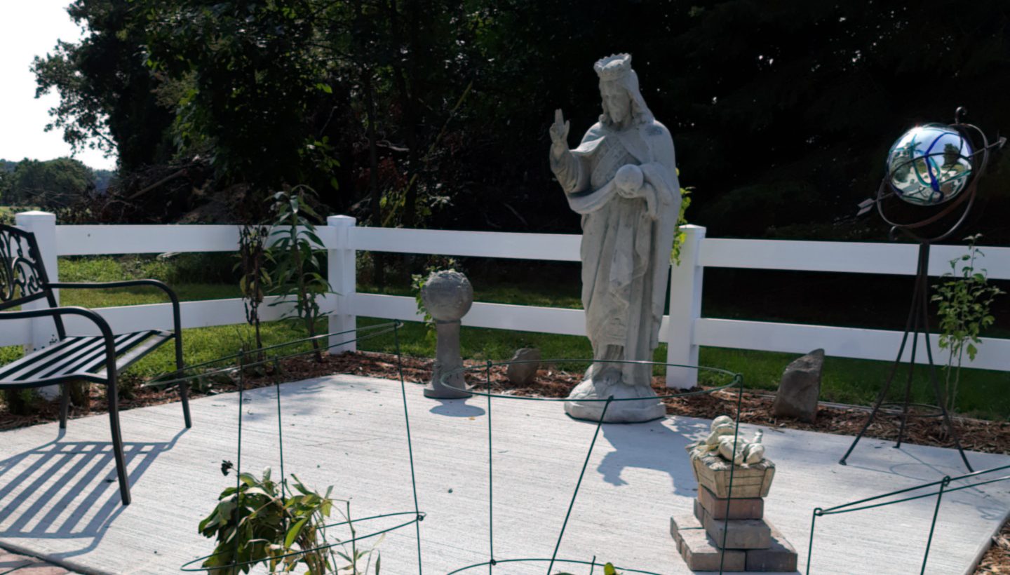 Photo of memorial garden with large statue of Jesus.